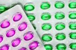 Green And Pink Oil Pills Stock Photo