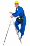 Young Worker Climbing On Stepladder Stock Photo