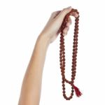 Rudraksha Rosary In A Female Hand. Japa Mala Stock Photo