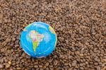 Many Whole Coffee Beans With South America On Globe Stock Photo