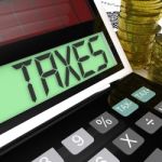 Taxes Calculator Shows Income And Business Taxation Stock Photo