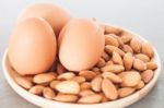 Almond Nuts And Eggs On Wooden Plate Stock Photo
