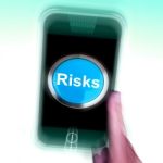 Risks On Mobile Phone Shows Investment Risks And Economy Crisis Stock Photo