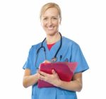 Lady Doctor Writing On Clipboard Stock Photo
