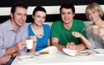 Happy Family Of Four At Restaurant Stock Photo