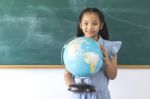 Asian Children Girl Observing And Studying Educational With Globe Model Stock Photo