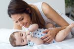 Mother And Baby Playing And Smiling At Home Stock Photo