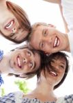 Circle Of Happy Friends With Their Heads Together Stock Photo