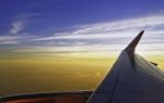 Sun Setting Over The Horizon Cloud Sky Twilight Through Airplane Stock Photo