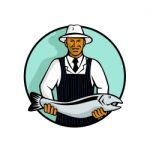 African American Fishmonger Holding Trout Stock Photo