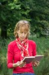 Woman Reading Book In Nature Stock Photo
