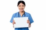 Physician Holding Blank White Ad Board Stock Photo