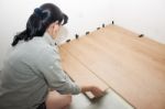 Young Woman Puting Laminate Flooring Stock Photo