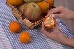 Woman Hands Peeling A Mandarin Stock Photo