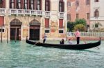 Two Gondoliers Ferrying Passengers Along The Canals Of Venice Stock Photo