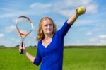 Young Dutch Woman Holding Tennis Racket And Ball Outdoors Stock Photo