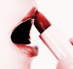 Applying Red Glossy Lipstick Stock Photo