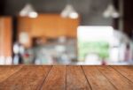 Tabletop With Abstract Blur Coffee Shop Background Stock Photo