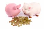 Two Piggy Banks With Euro Coins On White Stock Photo