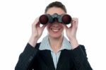 Businesswoman Looking Through Binocular Stock Photo