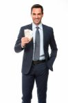 Half Lenth Portrait Of A Businessman Smiling In Falling Money Stock Photo