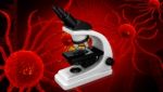 Microscope And Cancer Cell Stock Photo