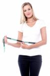 Young Woman Measuring Her Waistline Stock Photo