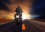 Man Riding Motorcycle On Highway Against Beautiful  Sun Set Sky Stock Photo