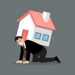 Desperate Businessman Carry A Heavy Home Stock Photo