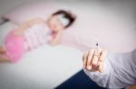 Doctor Preparing An Injection For A Little Asian Girl Stock Photo
