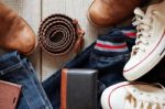 Clothing And Leather On Wooden Floor Stock Photo
