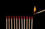 Burning Match With Row Of Matches Isolated On Black Background Stock Photo