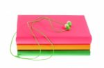 Headphones And Stack Of Multicolored Books On A White Background Stock Photo