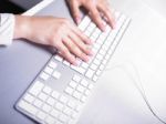 Woman Hand Typing On Keyboard Stock Photo