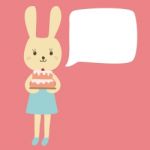 Rabbit Cartoon Holding A Birthday Cake With Bubble Space For Your Text Stock Photo