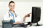 Female Doctor Pointing Screen Stock Photo
