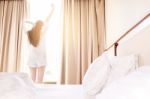 Healthy Woman Stretching In Bed Room And Open The Curtains After Stock Photo