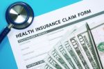 Health Insurance Claim Form With Money Stock Photo