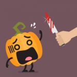 Hand With A Knife Prepare To Cut The Funny Pumpkin Character Stock Photo