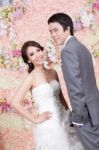 Newlywed Bride And Groom Posing With Flower Decorations Stock Photo