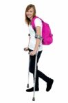 University Student Walking With Help Of Crutches Stock Photo