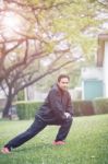 Healthy Asian Man Morning Exercise In Green Home Garden Stock Photo