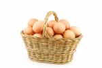 Eggs In A Wicker Basket On White Stock Photo