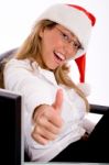 Side View Of Smiling Manager With Christmas Hat Showing Thumb Up Stock Photo