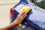Outdoor Blue Car Wash With Yellow Sponge Stock Photo