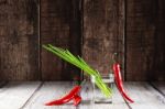 Green Onions And Red Hot Chilli Peppers In Glass Of Water Stock Photo
