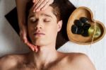 Relaxed Young Guy Getting A Face Massage Stock Photo
