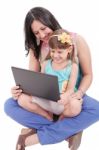 Young Mother And Daughter Looking At Laptop.  Focus In The Mothe Stock Photo