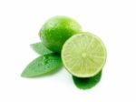 Green Limes With Leaves On White Stock Photo