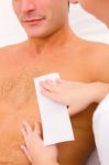 Man Waxing His Chest Hair Stock Photo
